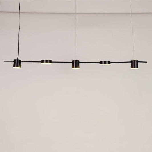 Linear pendant light turned on against white background showing evenly spaced light heads with sleek modern metal finish.
