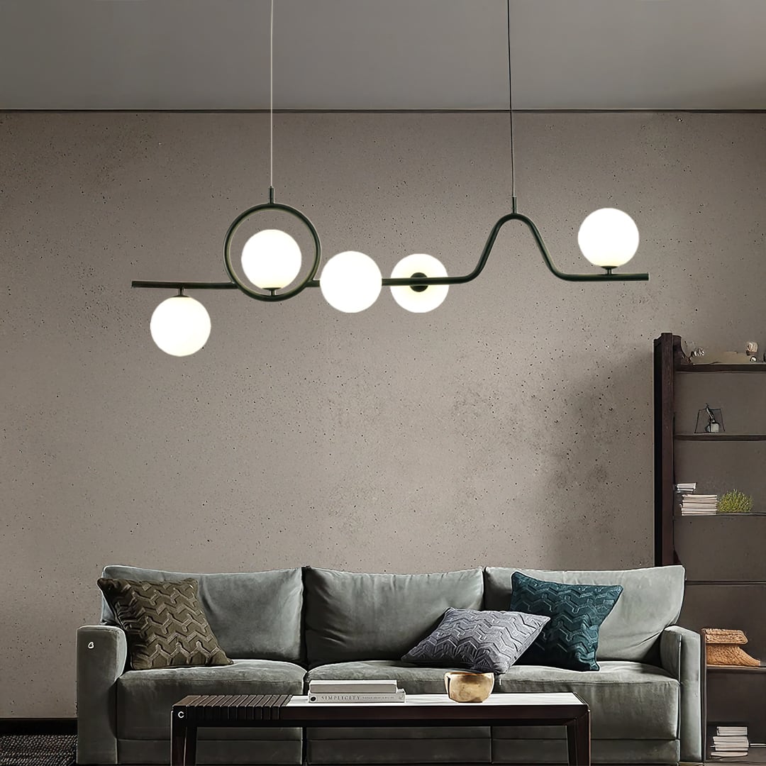 Black metal chandelier with frosted glass globes styled in a modern living space adding warm artistic ambient lighting.