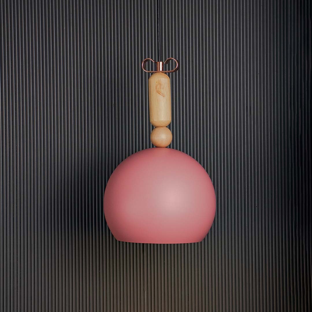 Terracotta dome pendant light glowing warmly on black background ideal for dining kitchen and living room lighting.