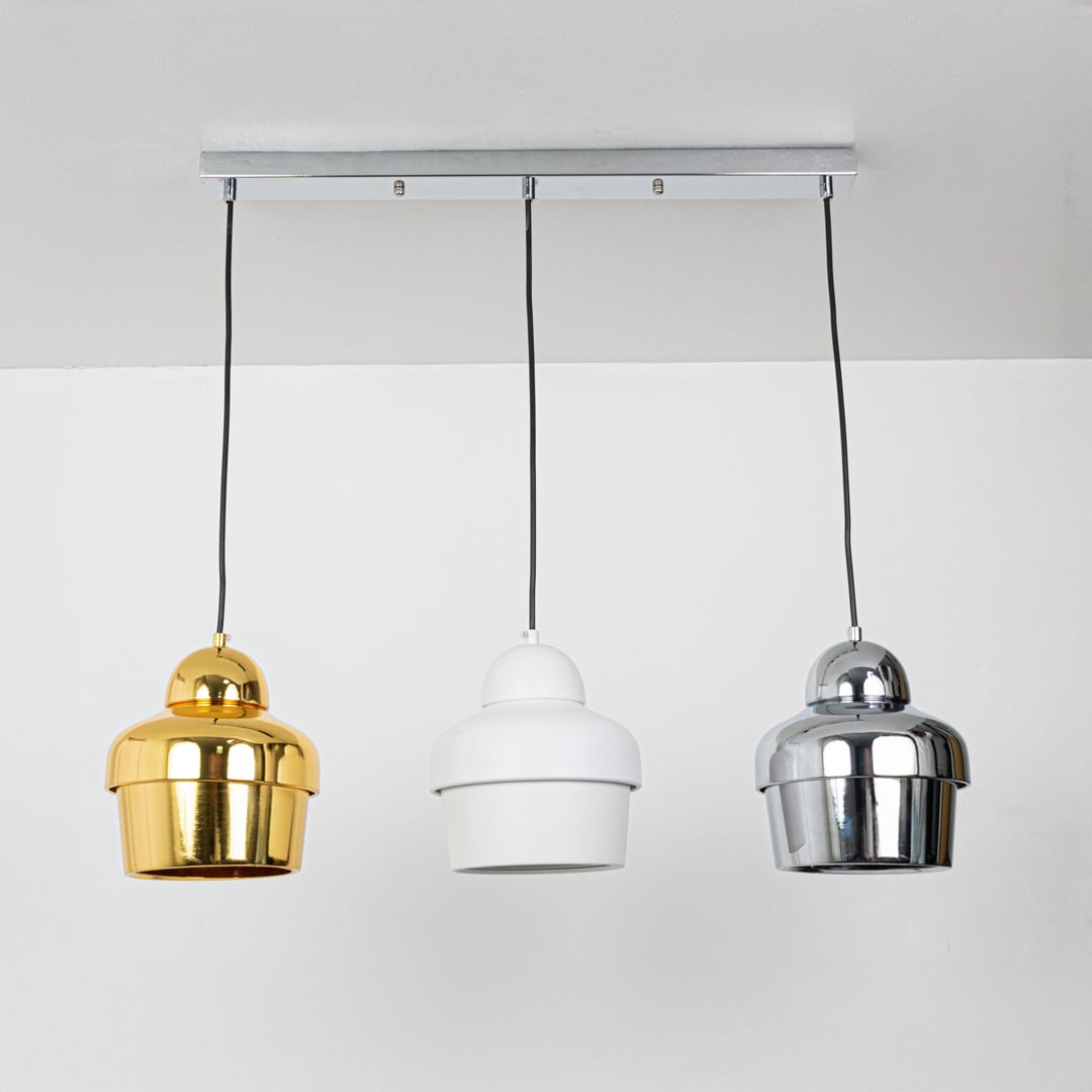 Gold white and chrome metal pendant lights displayed on a white background with lights off highlighting their sleek reflective finish and modern cylindrical design.
