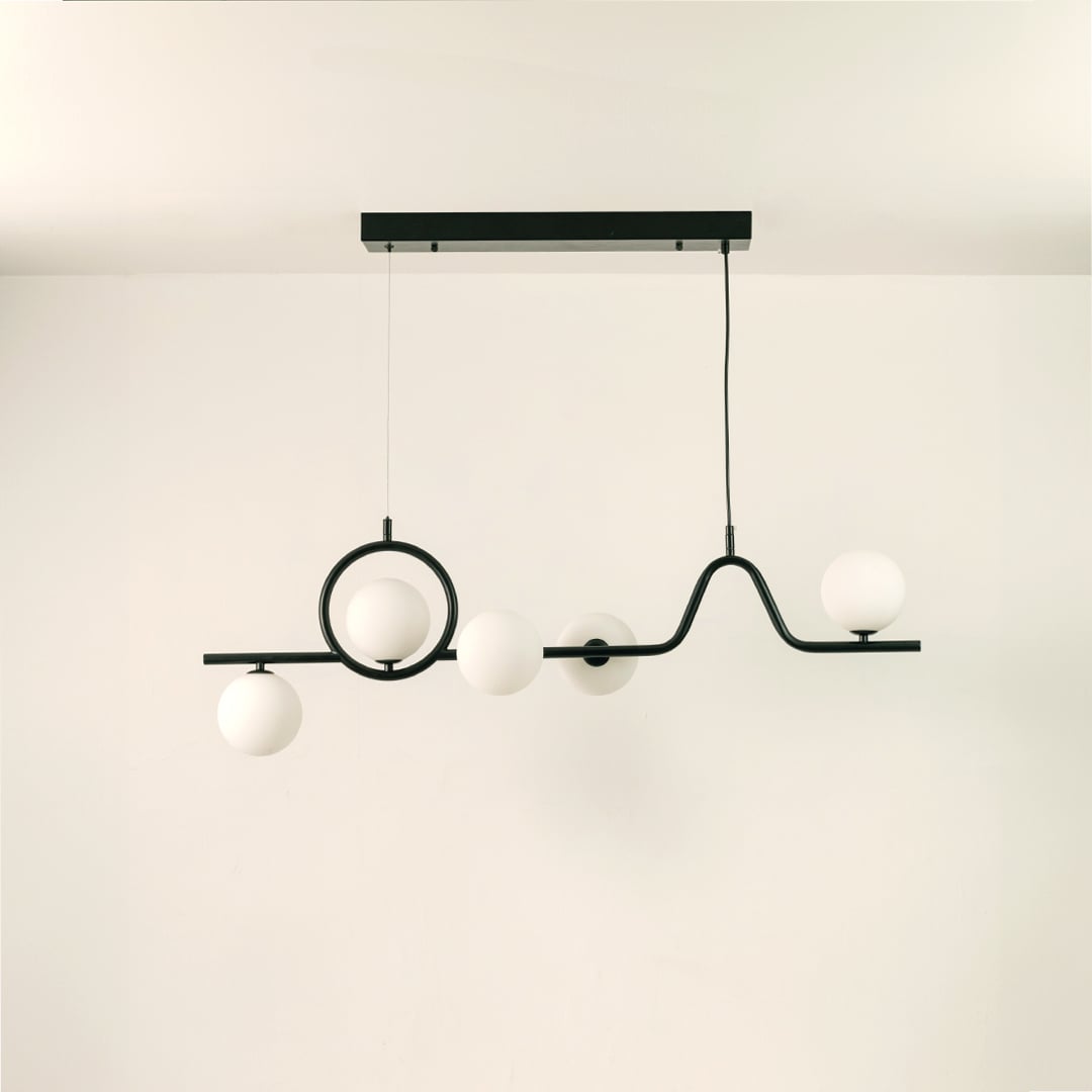 Black metal chandelier on a white background with lights off highlighting its artistic sculptural silhouette.