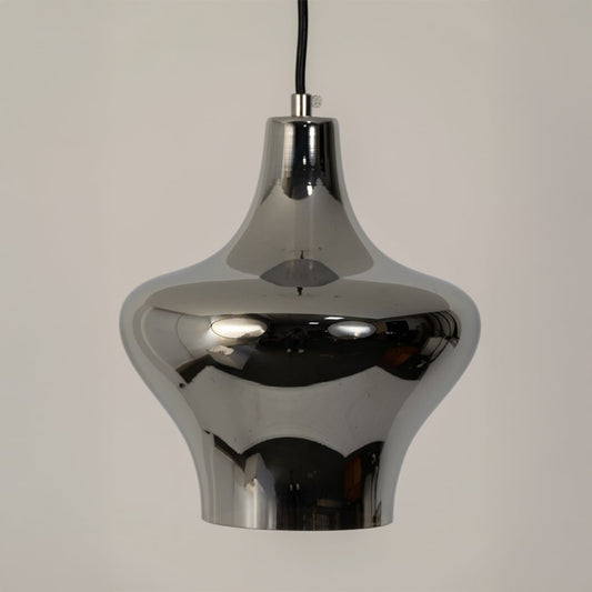 Closeup view of the chrome pendant light revealing its glossy reflective surface sculpted curves and premium modern detailing beautifully.