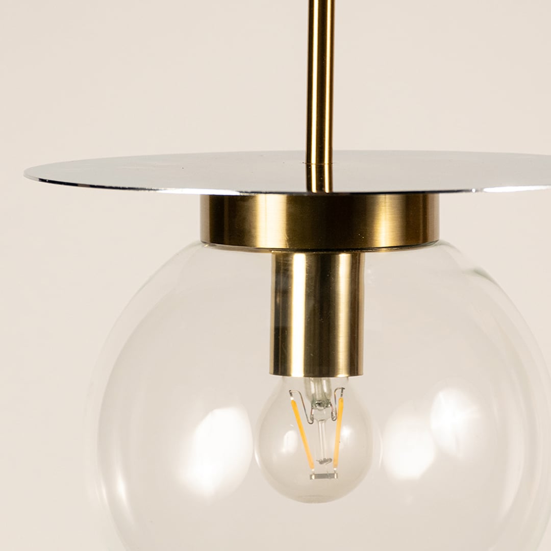 Close view of clear glass pendant hanging light showing detailed gold accent smooth surface and polished craftsmanship for modern decor.