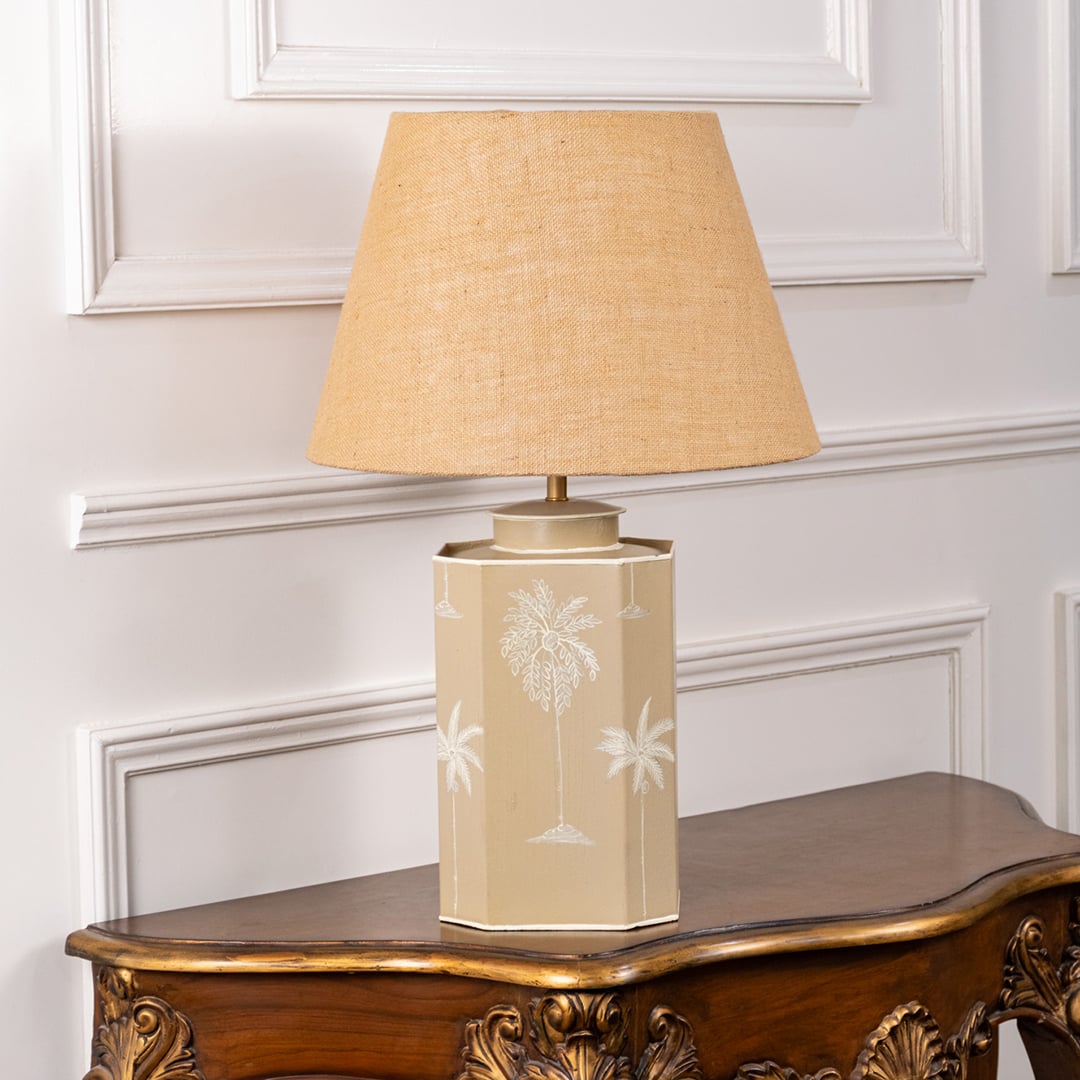 Palm design table lamp turned off featuring hand-painted beige ceramic base with white tropical palm detailing and natural jute shade perfect for modern decor.