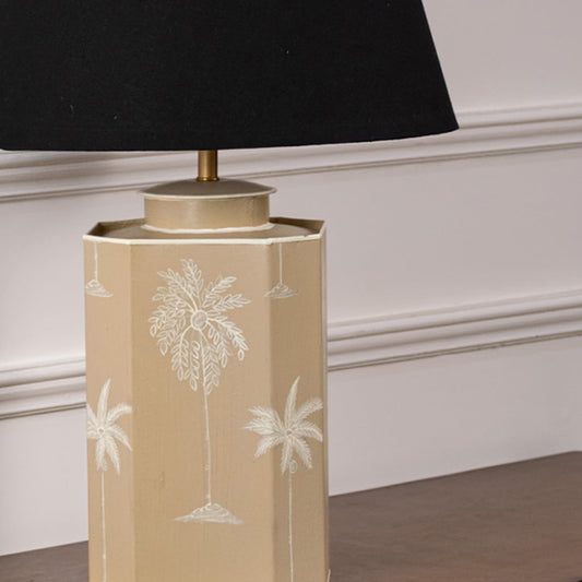 Closeup of palm tree table lamp showing fine white palm detailing on smooth beige ceramic base adding tropical elegance to contemporary decor.