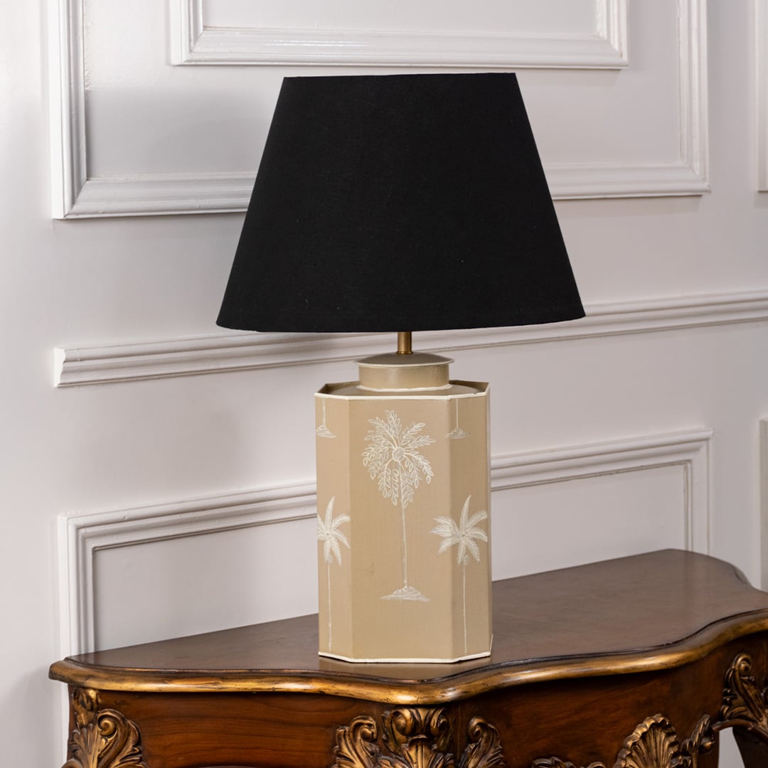 Palm tree table lamp turned off highlighting beige ceramic base with white palm motif and matte black shade perfect for modern home interiors.