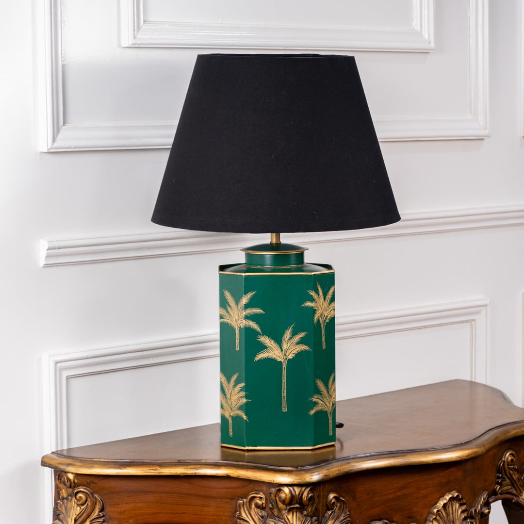 Green palm table lamp turned off highlighting hand-painted golden palm tree design on green ceramic base with black lampshade ideal for modern interiors and bedside tables.