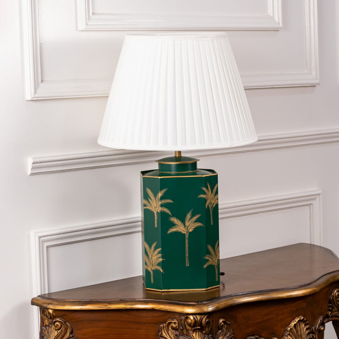 Green palm table lamp turned off showcasing glossy green ceramic base with gold palm design and pleated white shade ideal for bedroom or console table decor.