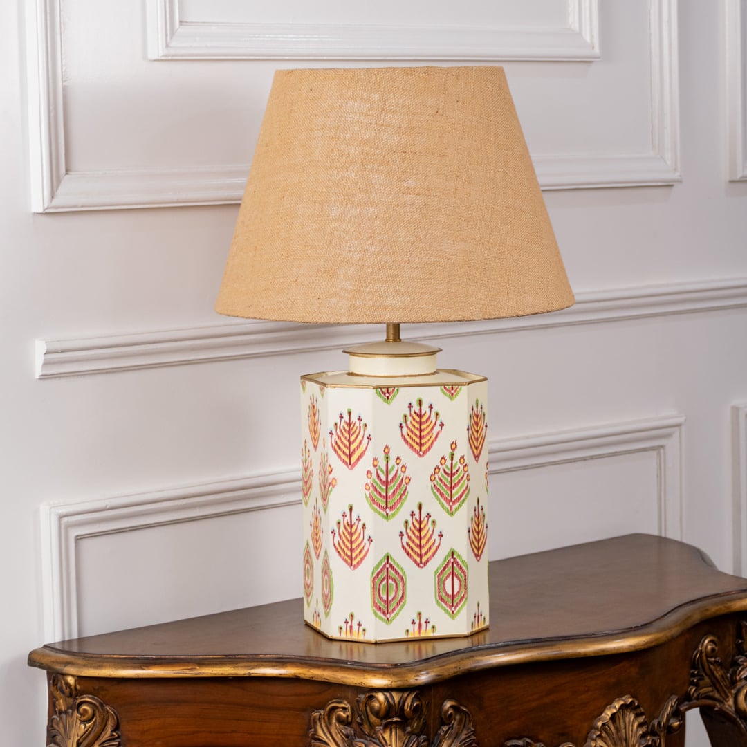 Ceramic lamp with beige shade displayed with lights off on a plain white background. The hand painted floral motifs and cream tone stand out beautifully for elegant and timeless home décor.