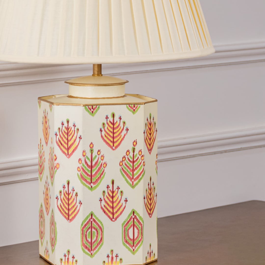 Closeup of ivory tribal pattern table lamp highlighting intricate hand-painted tribal motifs and fine gold detailing on an ivory ceramic surface for a sophisticated decorative appeal.