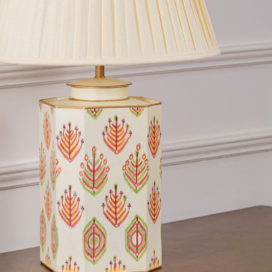 Closeup of ivory tribal pattern table lamp highlighting intricate hand-painted tribal motifs and fine gold detailing on an ivory ceramic surface for a sophisticated decorative appeal.