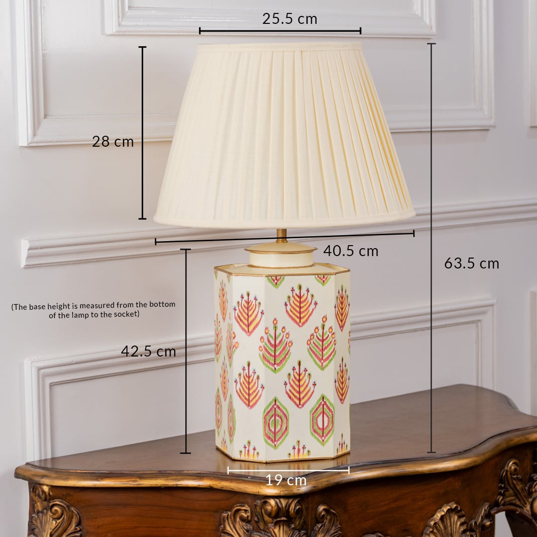 Ivory tribal pattern table lamp with cream pleated shade measuring 63.5 cm height and 42.5 cm base height with 25.5 cm top width 19 cm base width and 40.5 cm total width ideal for elegant interiors.