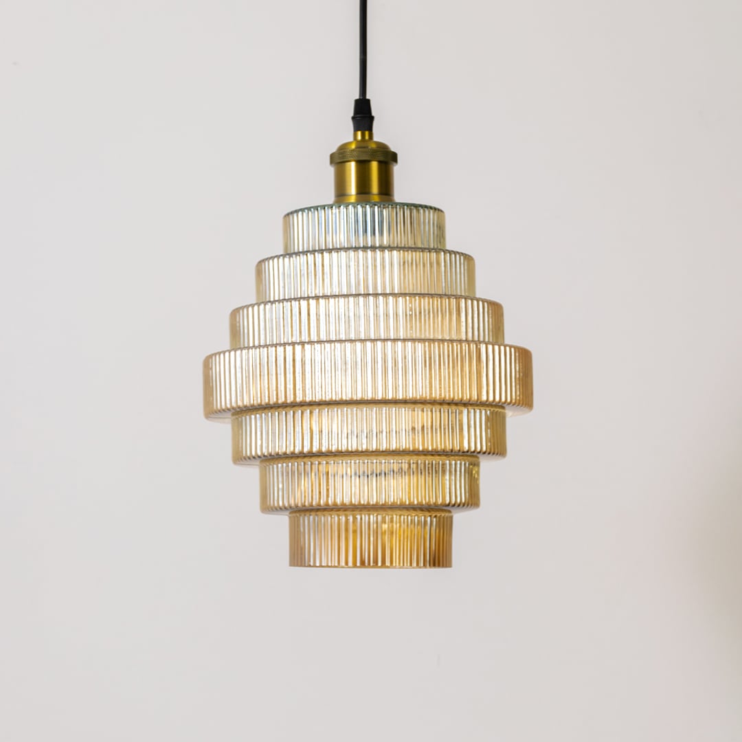 Tiered ribbed glass pendant light shown turned off against a white background highlighting its layered design and textured glass.