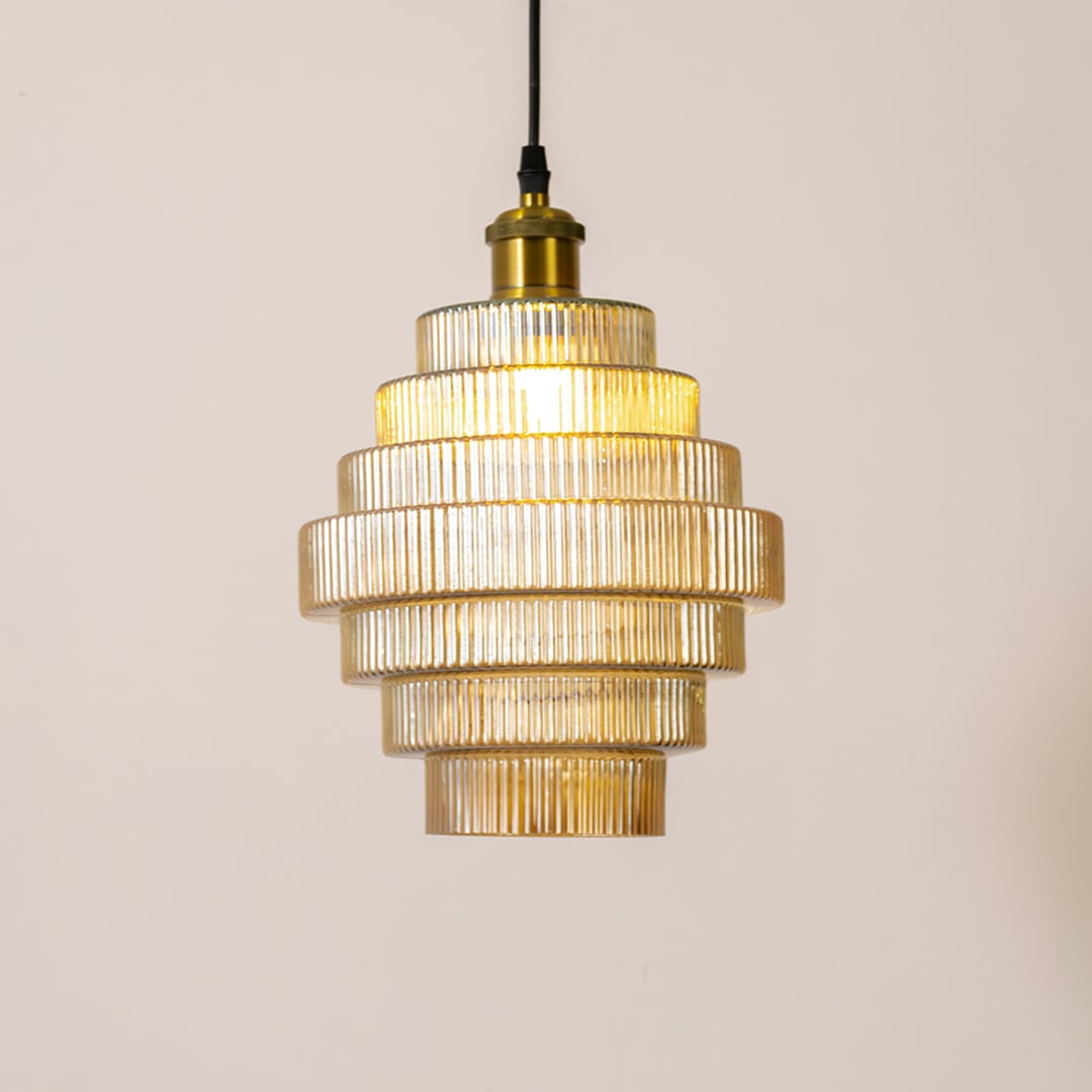 Tiered glass pendant light glowing on a clean white background highlighting its ribbed layered design and warm illuminated finish.