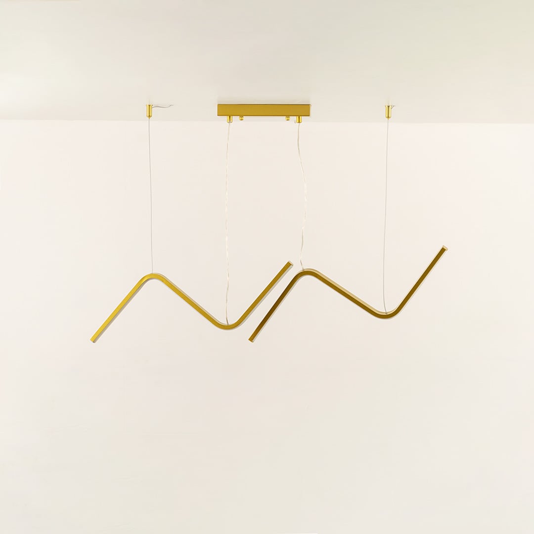 Gold wave LED chandelier featuring curved LED bars creating warm ambient illumination perfect for luxury dining rooms and high end interior lighting design.