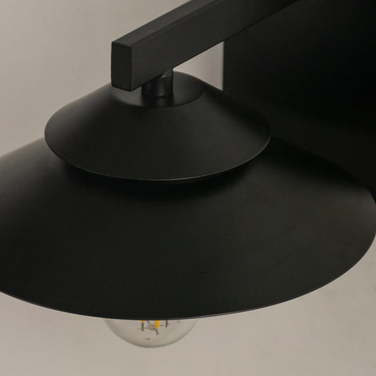 Close detailed view of the black wall light showing the layered shade metal finish and visible bulb for a clean contemporary lighting look.