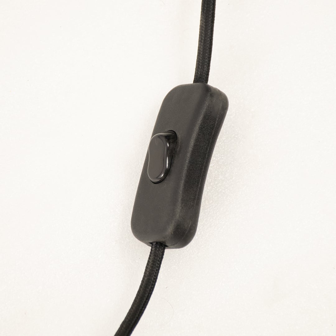 Closeup of black inline switch on power cord showing smooth toggle durable casing and easy control for table and floor lamps.