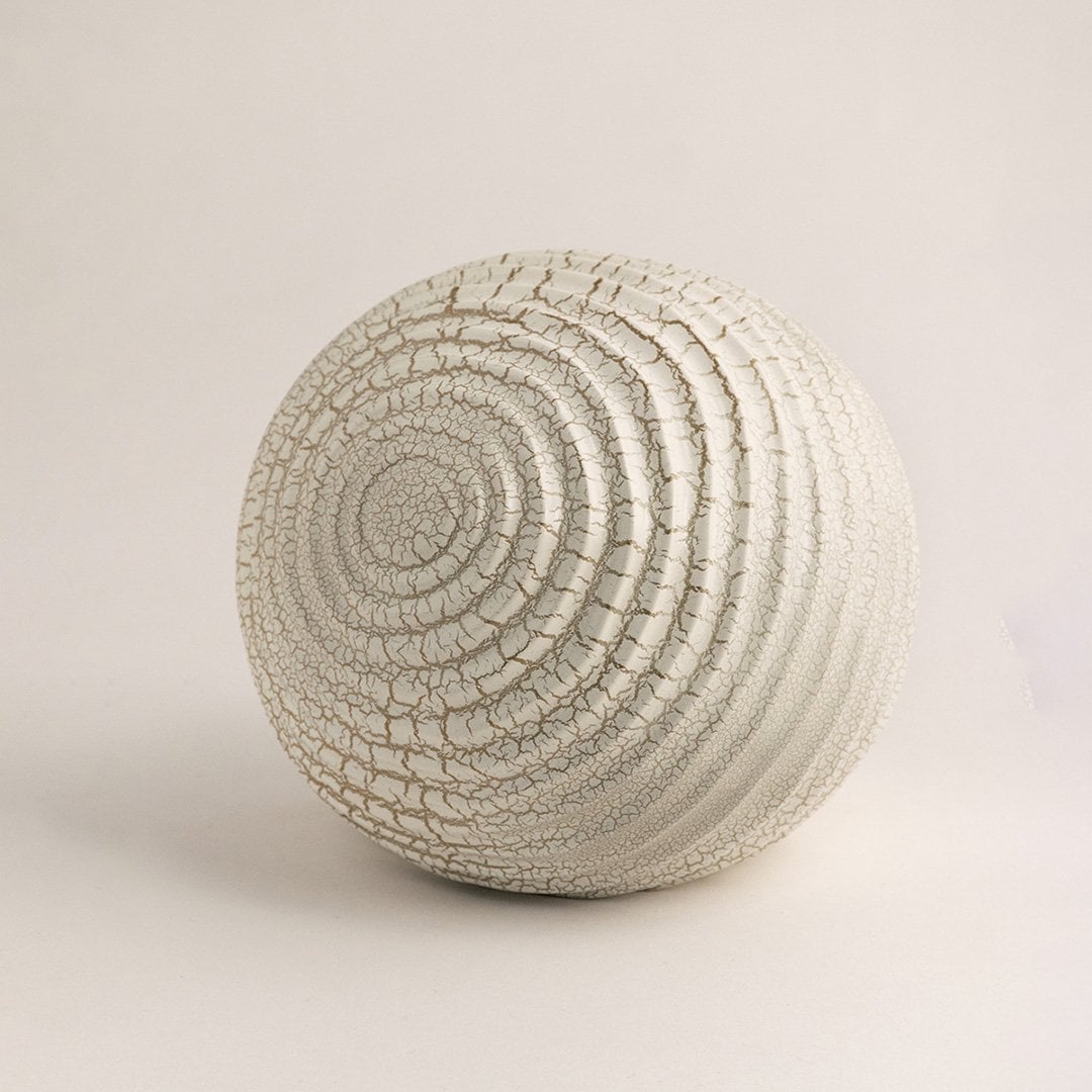 Off white ceramic sphere with textured crackle finish displayed on white background for modern decorative styling.