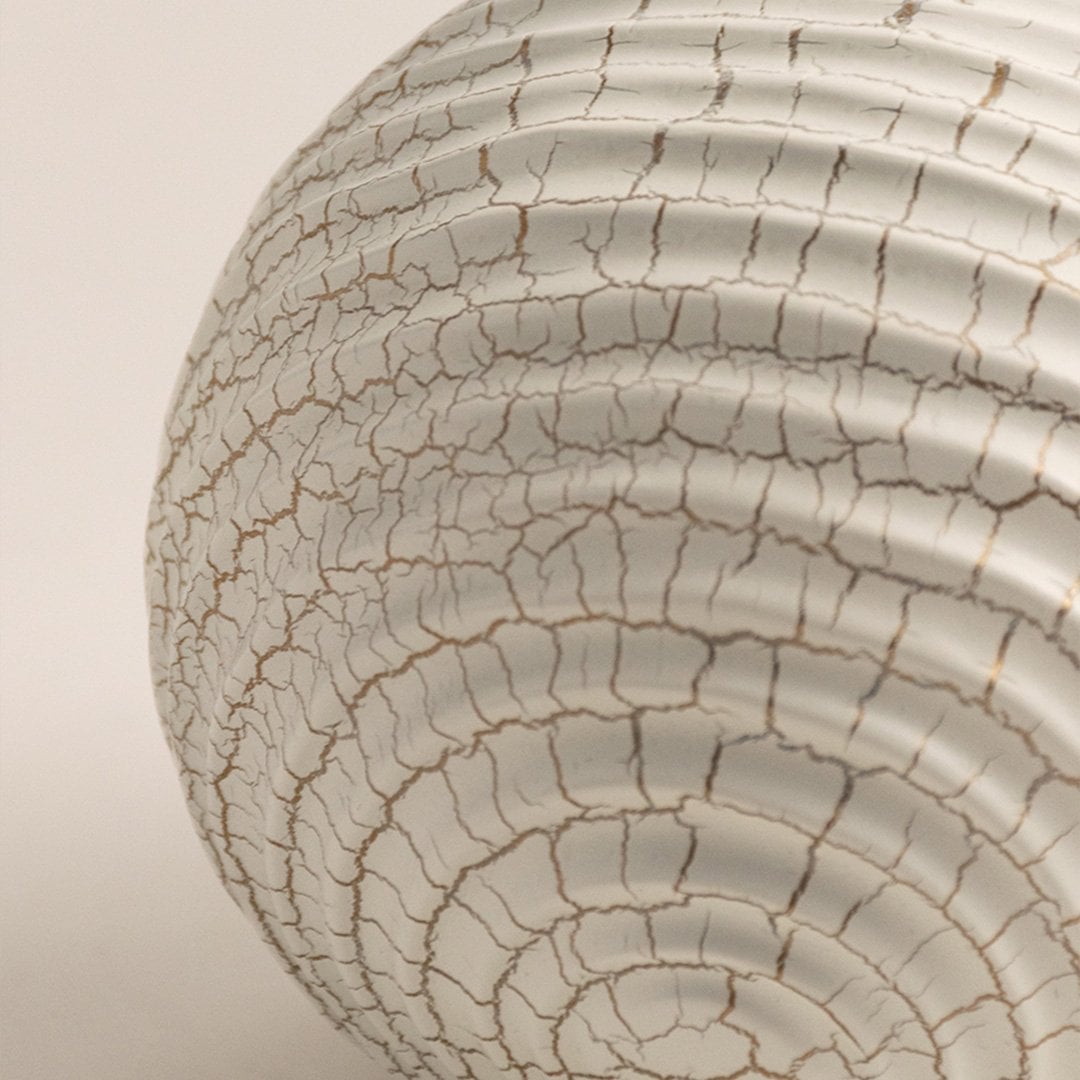 Closeup of white ceramic sphere with detailed crackle texture showing modern artistic finish and elegant design.