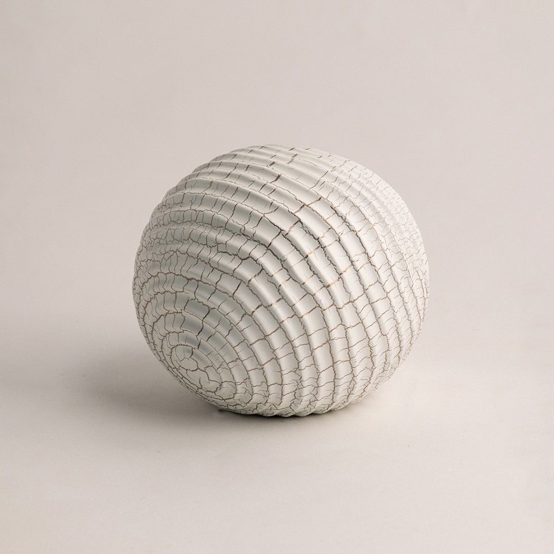 White ceramic decorative sphere with textured crackle pattern displayed on plain white background for styling.