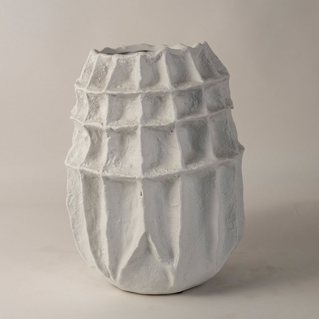 Contemporary white textured ceramic vase with sculptural design styled for modern living room and office interiors display.