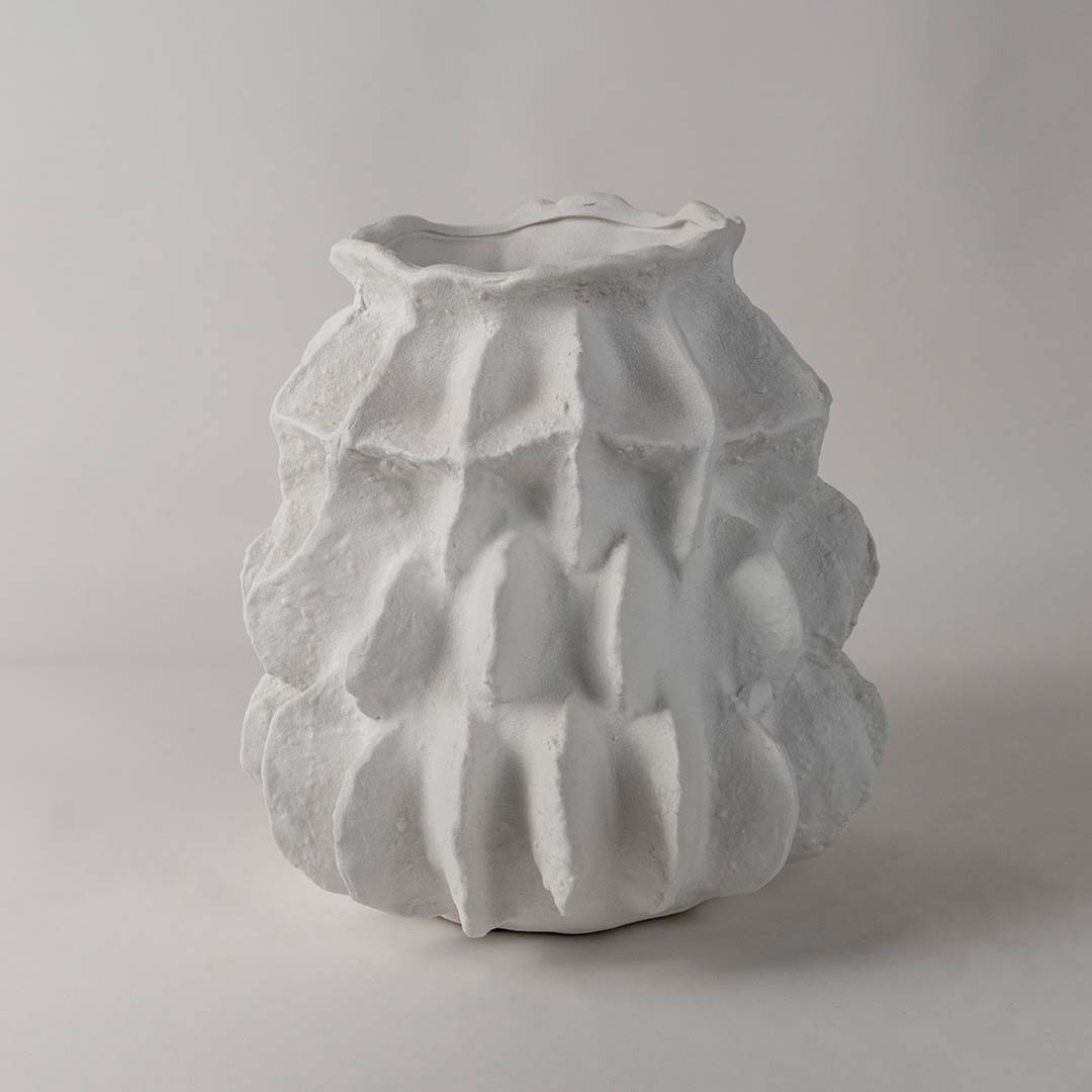 Side angle view of modern white ceramic vase with handcrafted sculptural finish perfect for living room and office decoration.