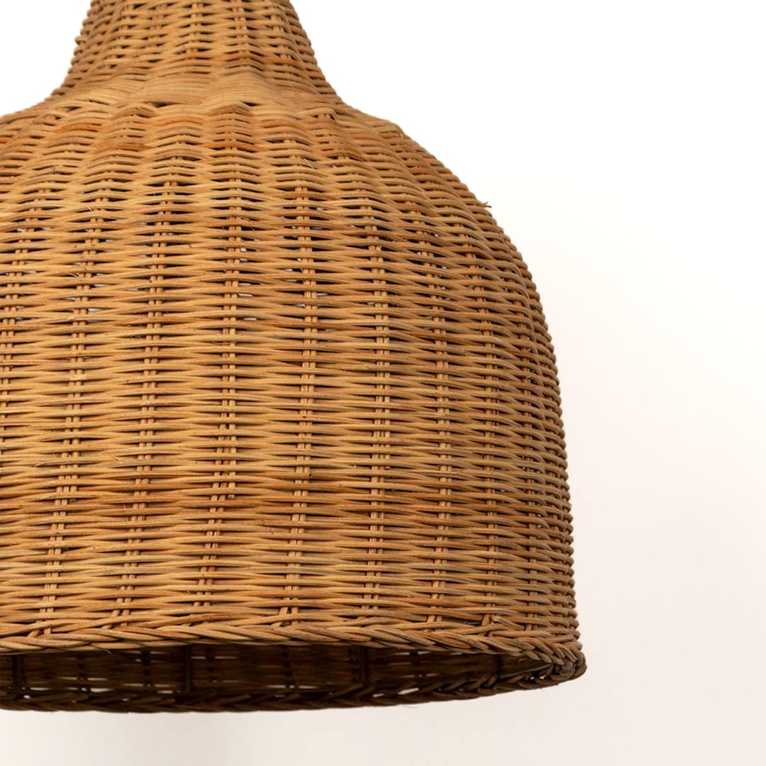 Closeup of dome-shaped rattan pendant light with handwoven bamboo shade in natural finish for rustic interiors.