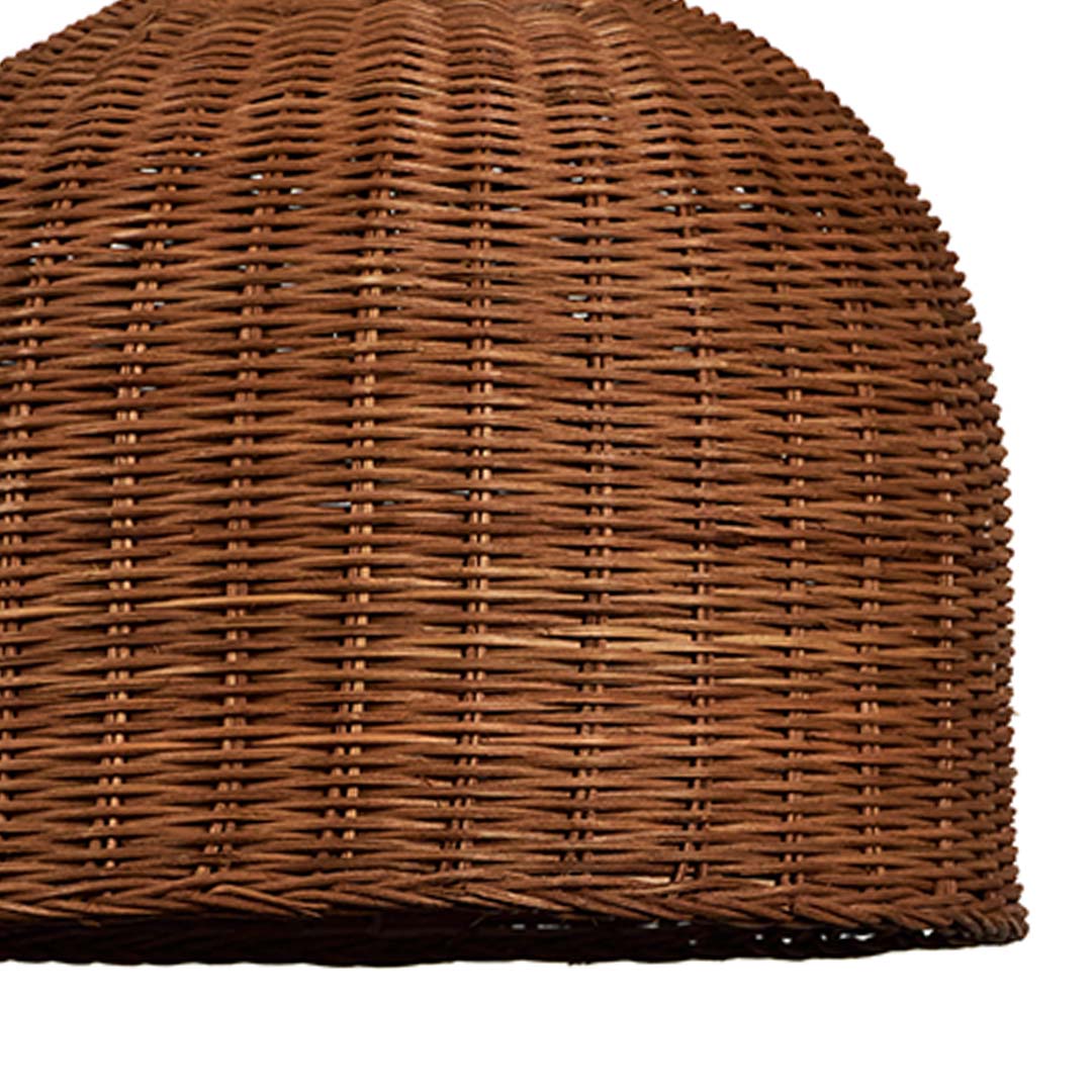 Closeup of handwoven rattan pendant light with natural wicker dome shade crafted for bohemian rustic home decor.