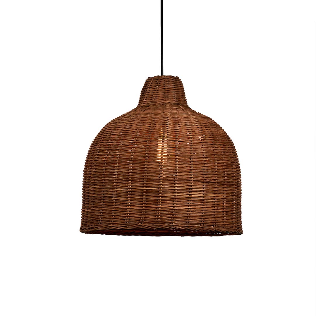 Rattan pendant light glowing on white background with natural wicker dome design for bohemian home interior lighting.