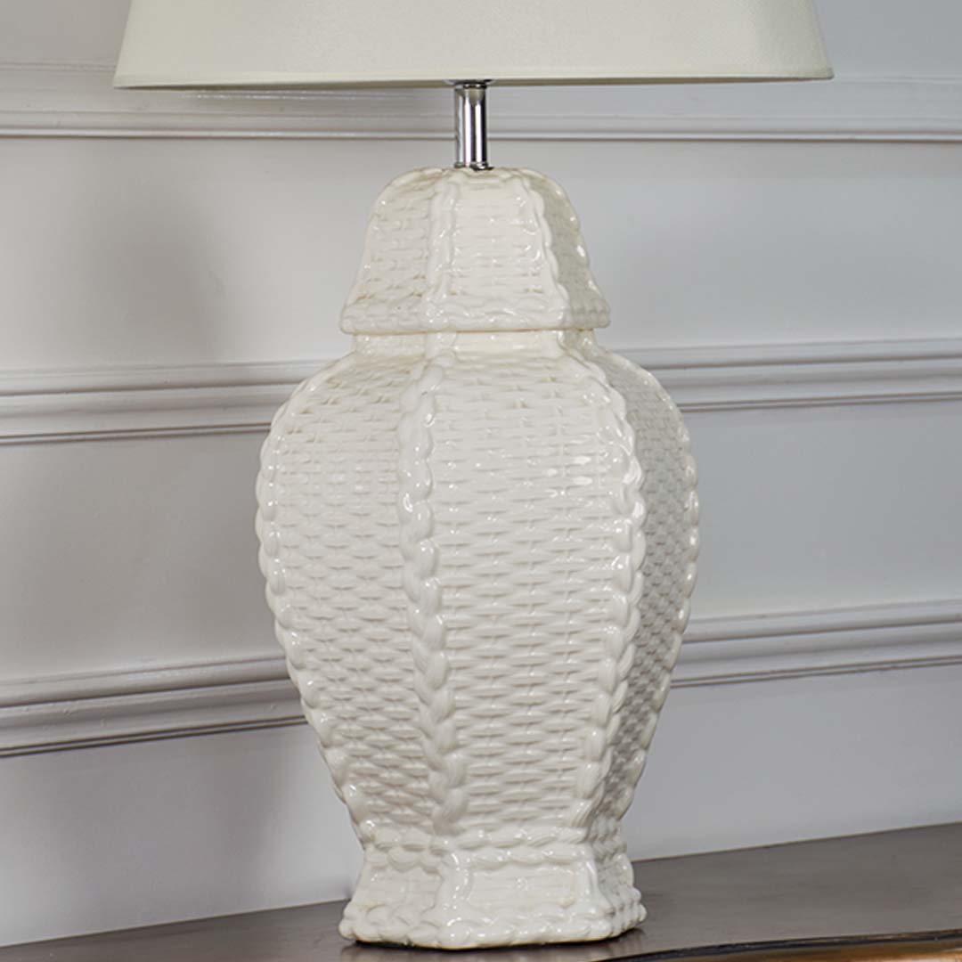 Closeup view of white ceramic table lamp with detailed woven texture and smooth cream shade highlighting premium craftsmanship and modern style.