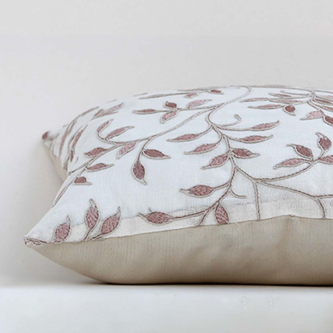 White cotton cushion cover with brown and grey embroidered botanical patterns adding artisan charm to home décor with a soft smooth and skin friendly material finish.