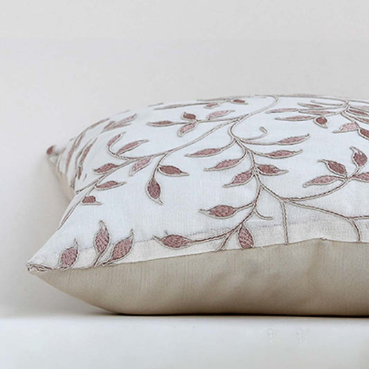 White cotton cushion cover with brown and grey embroidered botanical patterns adding artisan charm to home décor with a soft smooth and skin friendly material finish.