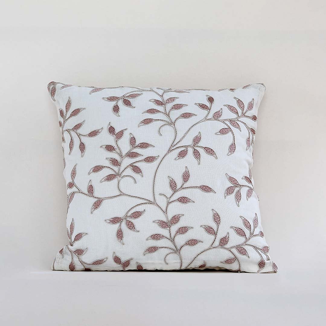 White cotton cushion cover featuring maroon botanical motifs adding an artistic natural décor touch with a breathable soft and skin friendly fabric ideal for contemporary spaces.