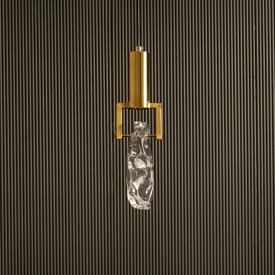Unlit modern pendant lamp on dark background highlighting its geometric metal structure and artfully shaped clear glass elegance.