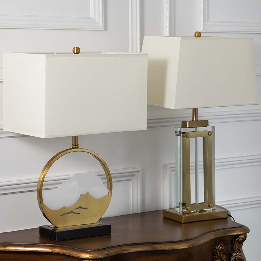 Gold metal table lamp with mountain detail base and rectangular shade shown on a black background offering a refined modern decor accent for home interiors.