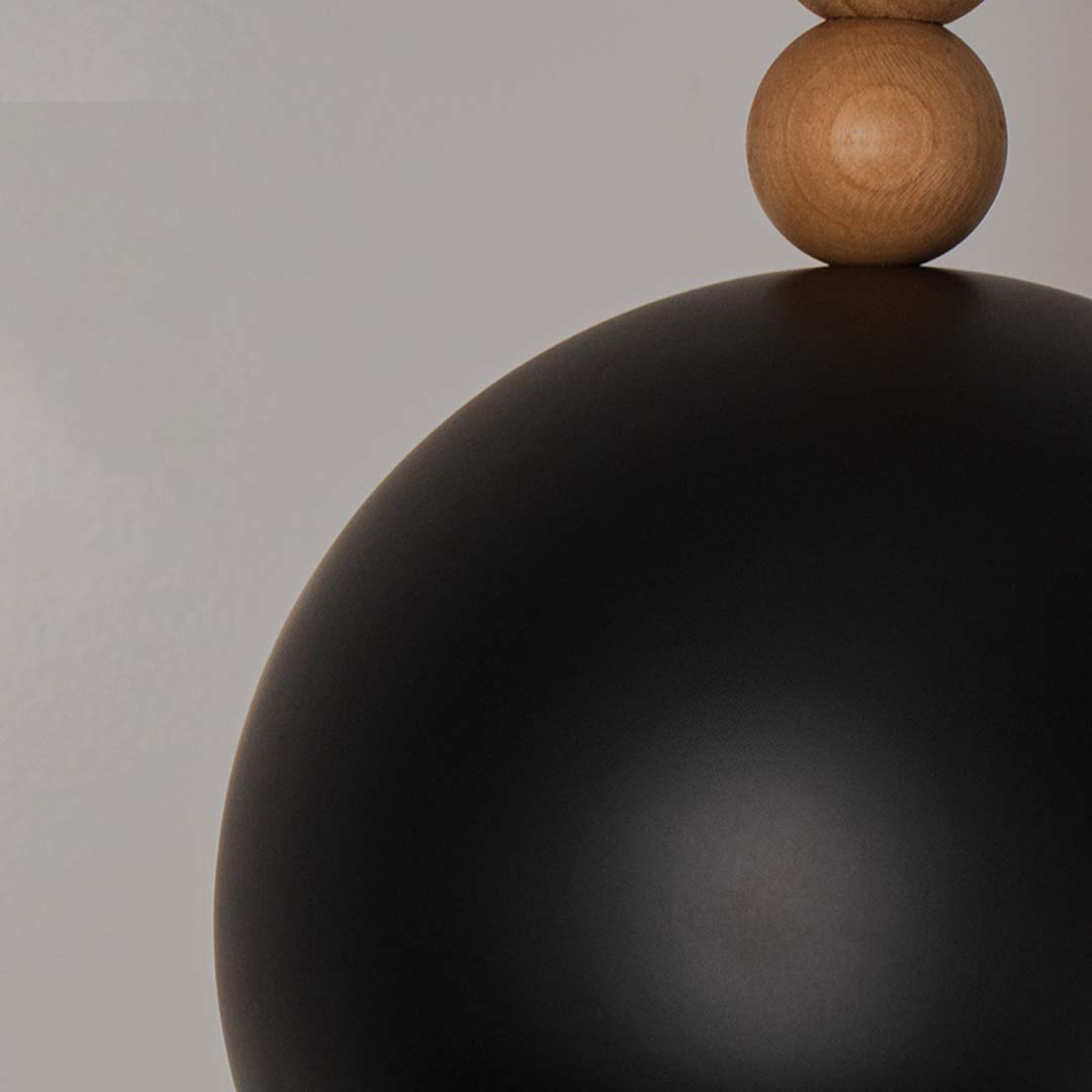 Outdoor garden pathway illuminated by decorative solar post lights casting warm light patterns along stone paving with landscaped flowers at dusk.