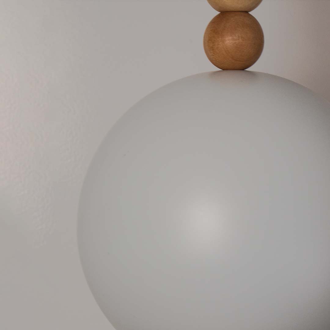 Closeup of frosted glass light shade with smooth matte finish and wooden accent detail for modern decor lighting.