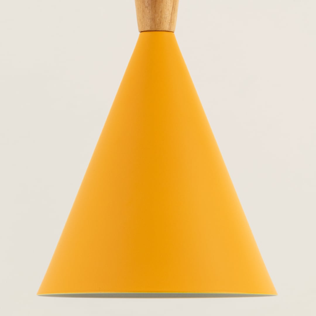 Detailed closeup of a yellow cone pendant light with smooth matte finish and wooden accent.