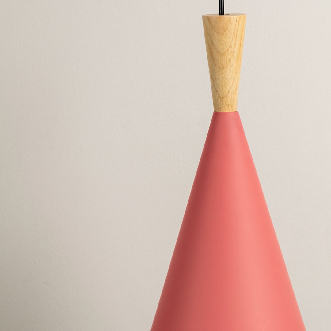 Detailed closeup of red cone pendant light with natural wood top showing smooth matte finish and sleek design.