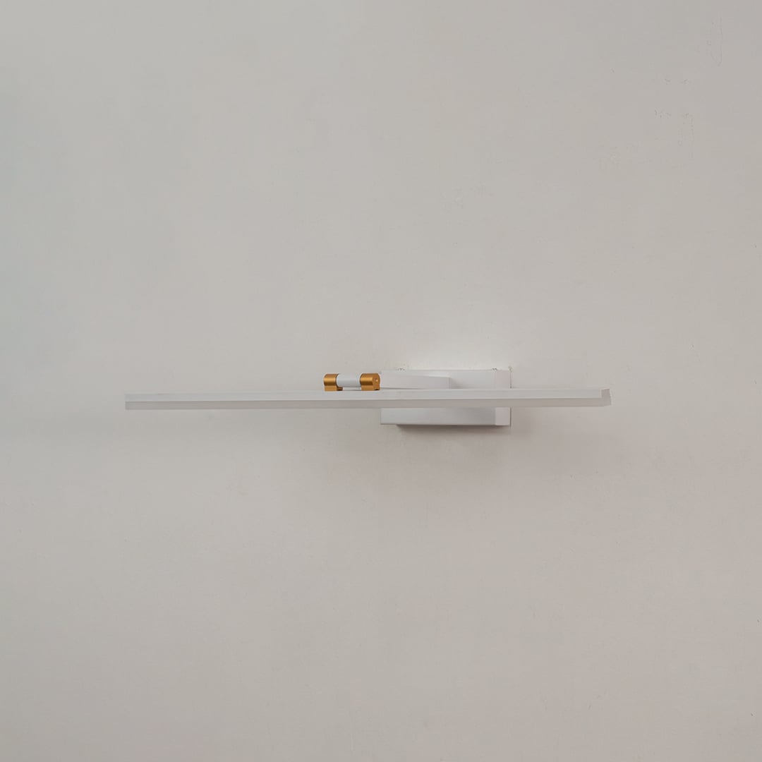 White and gold metal picture light on a white background with the light off highlighting its minimal modern design.