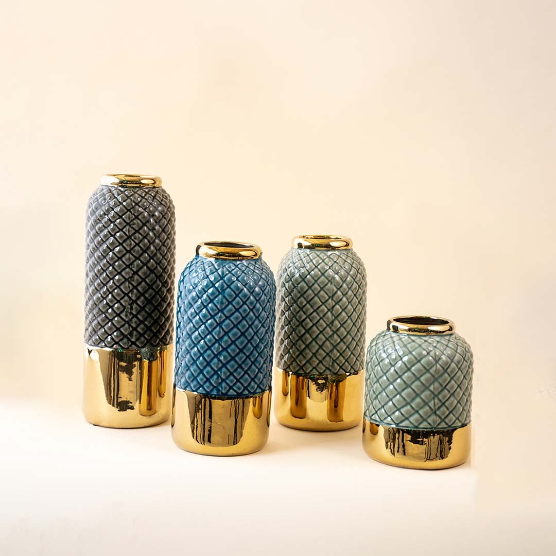Set of textured vases in blue grey and teal shades with gold bases arranged together for a stylish decorative display that highlights elegant home decor accents.