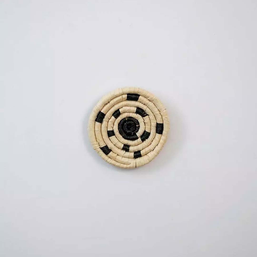 Round bamboo wall plate in yellow beige tones with woven spiral pattern perfect for boho natural wall decoration.