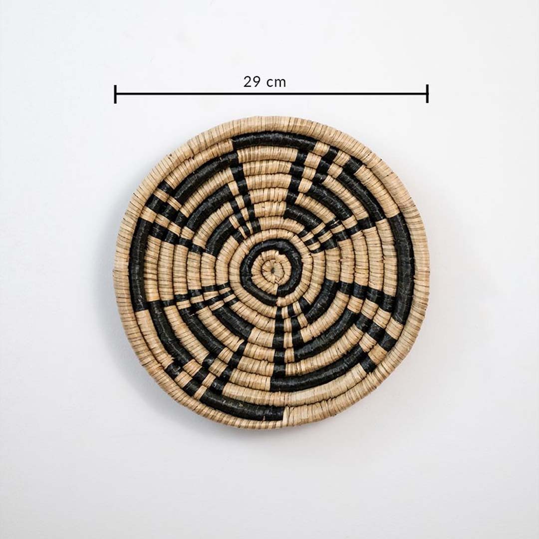 Circular woven wall basket with geometric black and beige pattern showing 25 cm diameter ideal for accent wall decor styling.