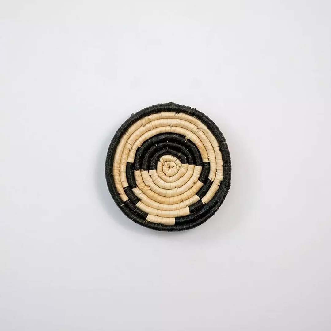 Natural fiber wall basket with black tribal pattern displayed on white background for stylish wall decor.