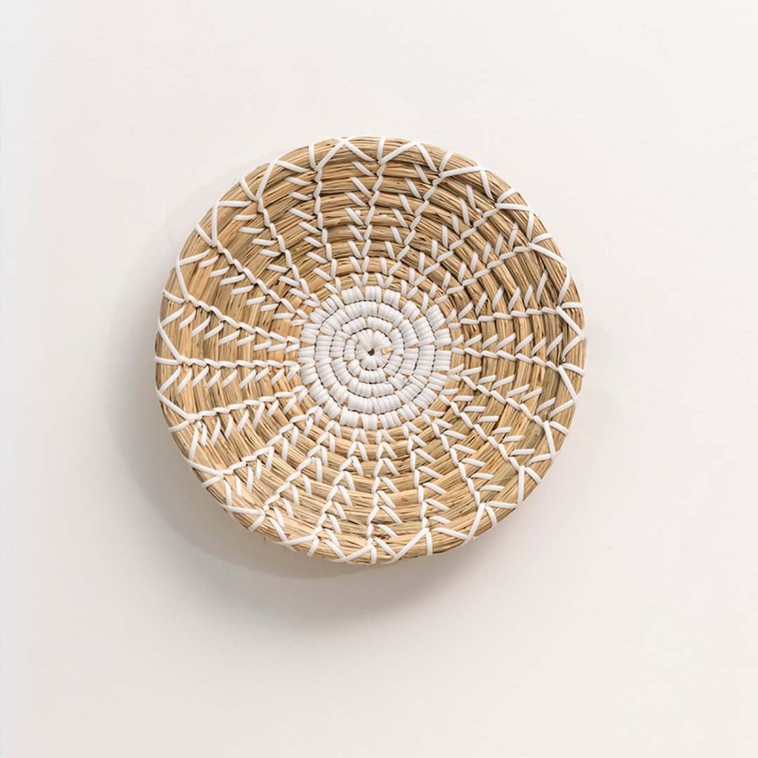 Handwoven round wall basket in natural beige fiber displayed on white background for minimal boho wall Decor styling.