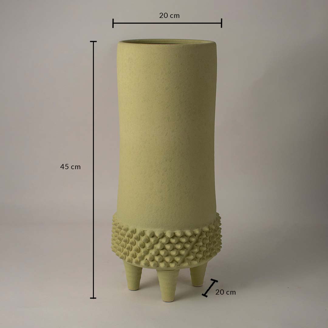 Green ceramic vase measuring 45 cm height and 20 cm width shown on white background with textured tripod base design.