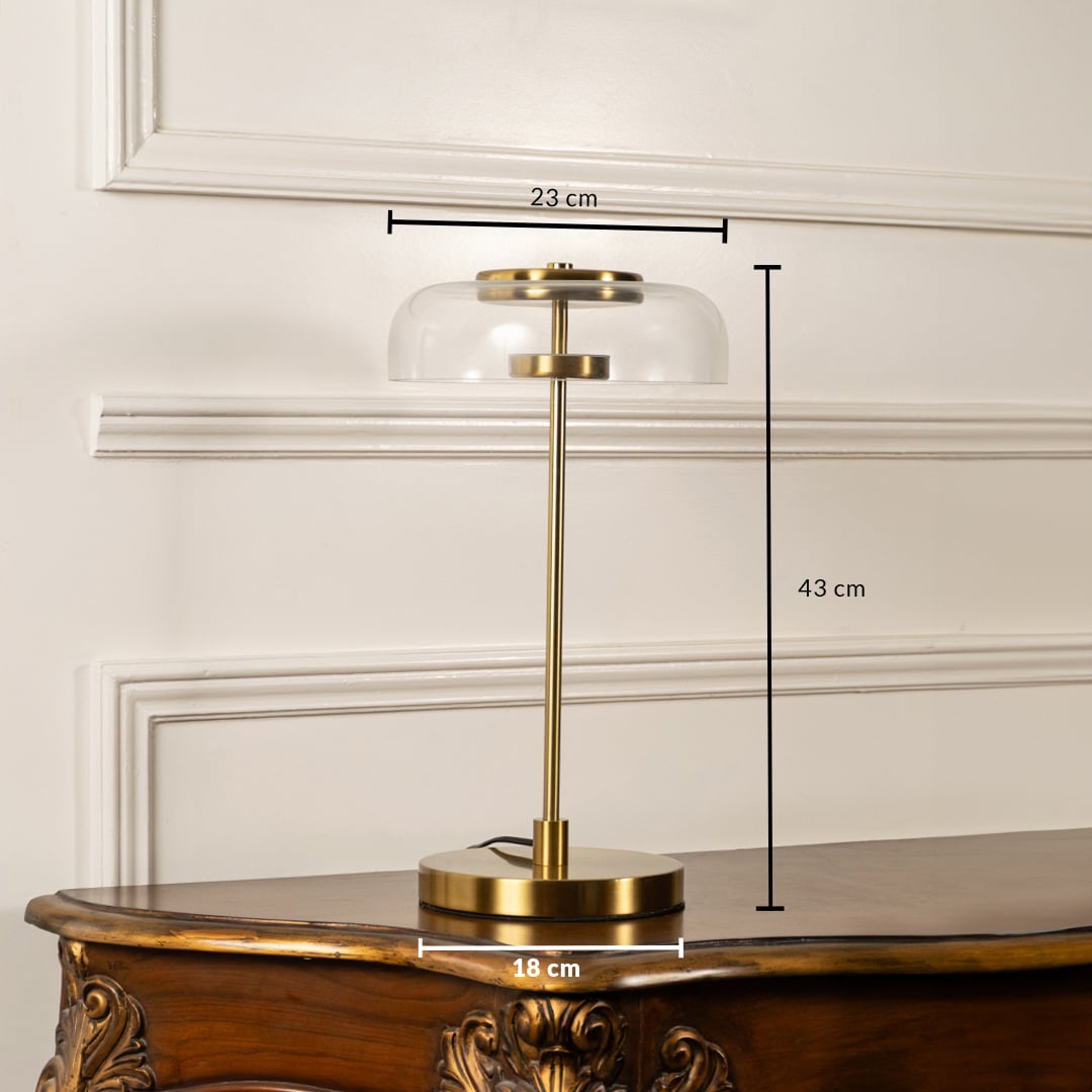 Gold and glass dome table lamp with slim metal stem shown with dimensions of 23 cm width 43 cm height and 18 cm base diameter ideal for bedside or study placement.