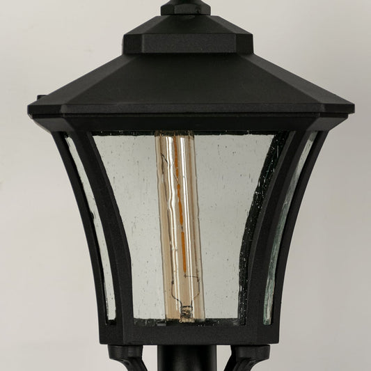 Closeup of black outdoor wall lantern with clear glass panels highlighting sturdy metal frame and classic exterior lighting.