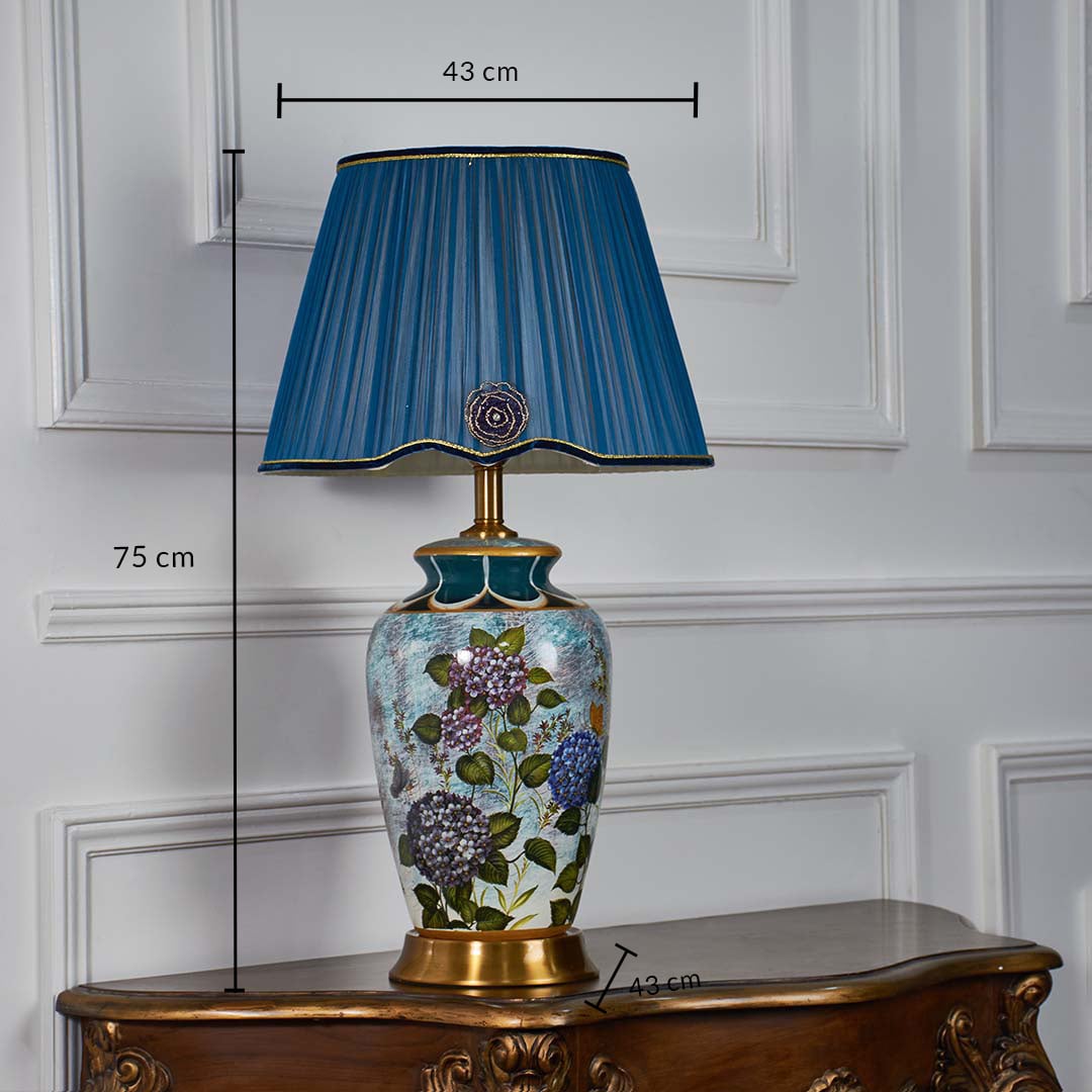 Blue floral ceramic table lamp shown with 75 cm height 43 cm shade width and 43 cm base width on a wooden console for precise size reference.
