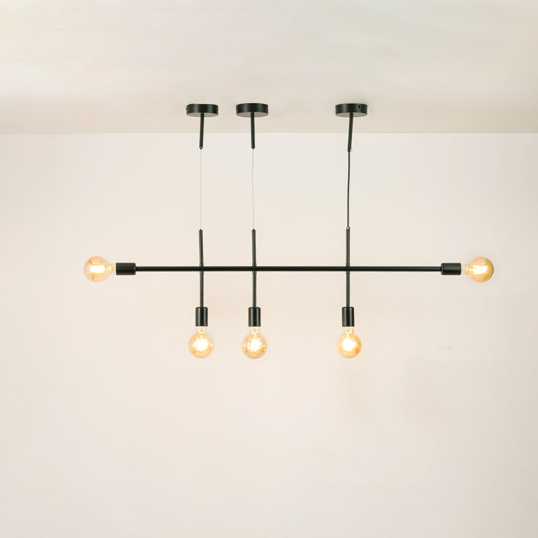Black linear chandelier with glowing globe bulbs on a clean white background showcasing its sleek minimal modern design.